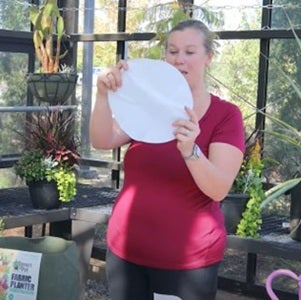 Carrie holding a large seed disc for planting